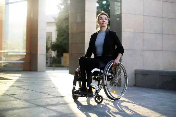 A woman in a manual wheelchair outside an office building